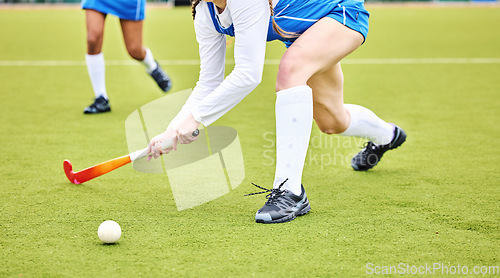 Image of Hockey, closeup and female athlete playing a game, match or tournament on an outdoor field. Fitness, sports and young woman training or practicing a defence strategy with a stick and ball at stadium.