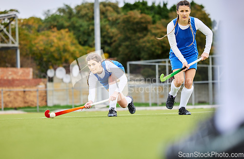 Image of Fitness, workout and female hockey players training for a game, match or tournament on an outdoor field. Sports, exercise and young women playing at practice with a stick and ball on pitch at stadium