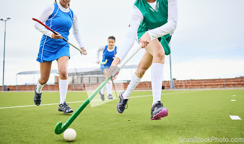 Image of Sports, fitness and female hockey athletes playing game, match or tournament on an outdoor field. Equipment, exercise and young women training or practicing for strategy with stick and ball on pitch.