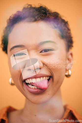 Image of Happy, woman and tongue out face in studio with smile and confidence feeling silly. Orange background, young portrait and African female person with trendy, modern and student fashion with gen z glow