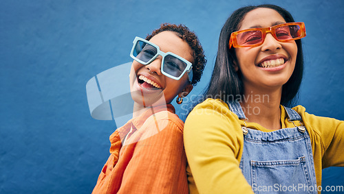 Image of Sunglasses, fashion and portrait of friends on blue background with trendy clothes, accessories and style. City, summer clothes and face of happy women with smile on holiday, vacation and weekend