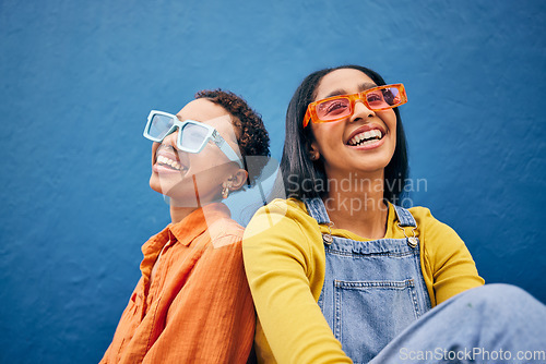 Image of Sunglasses, fashion and women on blue background by wall with trendy clothes, accessories and style. Happy, summer clothes and face of female people with smile on holiday, vacation and weekend