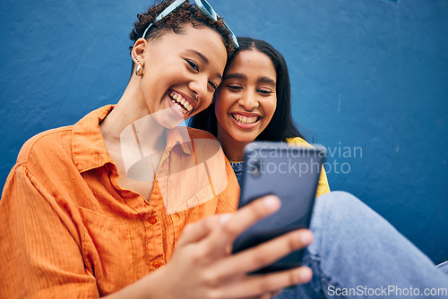 Image of Phone, happy and women in city on blue background for social media, online post and browse internet. Friendship, smile and female people on smartphone in urban town for bonding, holiday and travel