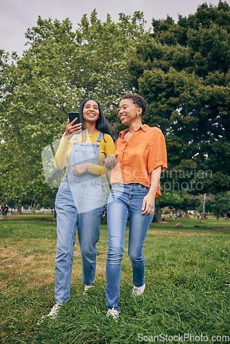 Image of Women, park and girl friends on walk outdoor with laugh, bonding and friendship in nature. Urban, city garden and phone with gen z, young and female people on holiday with freedom and happy in spring