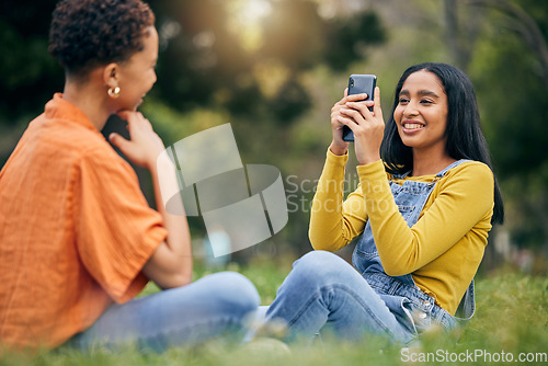 Image of Phone, photography and women at a park relax, bond and having fun on the weekend together. Profile picture, smartphone and female friends in forest with photo, memory and social media post in nature