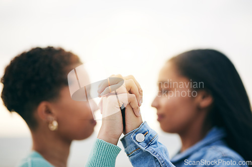 Image of Holding hands, lesbian and queer couple with love, outdoor and romance with support, bonding and quality time. Closeup, fingers and women with holiday, romantic and loving together with Lgbtq people