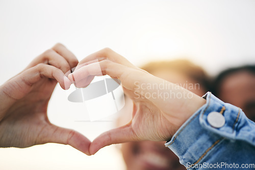 Image of Closeup, support and couple with heart hands, outdoor and relationship with growth, health and icon. Zoom, people and lovers with symbol for romance, care and happiness with gesture and solidarity