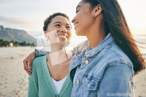 Image of Beach, hug and queer couple with love, lgbtq and happiness with marriage, sunset or adventure. Lesbian, female people or women on a seaside holiday, vacation or quality time with a journey or embrace