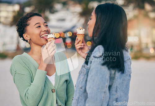 Image of Ice cream, beach and lesbian couple eating dessert in sunset together on an outdoor vacation or holiday for romance. Lgbtq, pride and women bonding on a summer date for love, relax and happiness