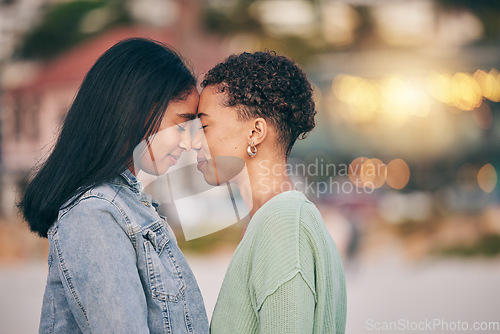 Image of Lesbian, couple and forehead touch with love on outdoor, date and calm moment on the beach with support of partner in relationship. Happy, women and face together with peace, kindness and affection