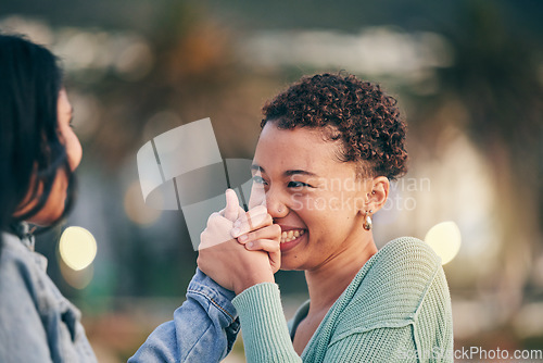 Image of Holding hands, happy and a lesbian couple in the city with love, excited and support together. Laughing, smile and women in a young lgbt relationship with trust, comic and kindness on a date