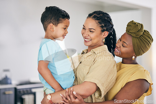 Image of LGBT, kid and happy couple hug, care and smile for home bonding, child support and enjoy quality time together. Family, hugging and gay people, queer mothers or lesbian women connect with adopted son