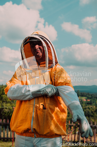 Image of Beekeeper put on a protective beekeeping suit and preparing to enter the apiary