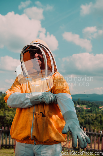 Image of Beekeeper put on a protective beekeeping suit and preparing to enter the apiary