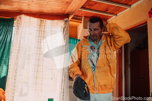 Image of Beekeeper put on a protective beekeeping suit and preparing to enter the apiary