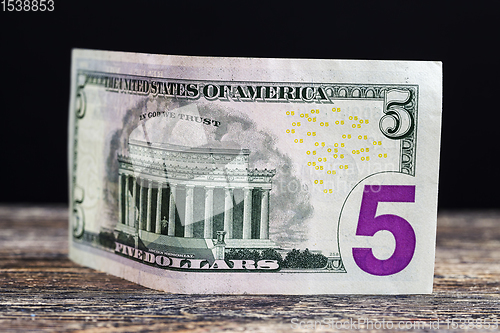 Image of five American dollars in cash