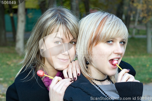 Image of Portrait of the two young women with sugar candies
