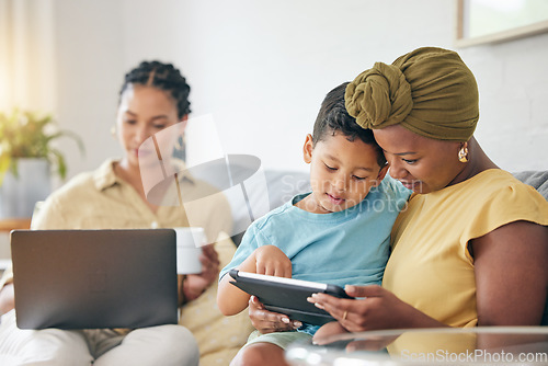 Image of Technology, tablet and family child, mom or black woman reading online ebook, e learning and remote education. Studying, lesbian mothers or relax gay people teaching kid on home living room couch