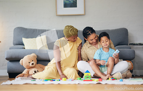 Image of Playing, gay family and child with toys on a home floor for development, education and learning. Adoption, lesbian or LGBT women or parents and kid together in a lounge for quality time and fun