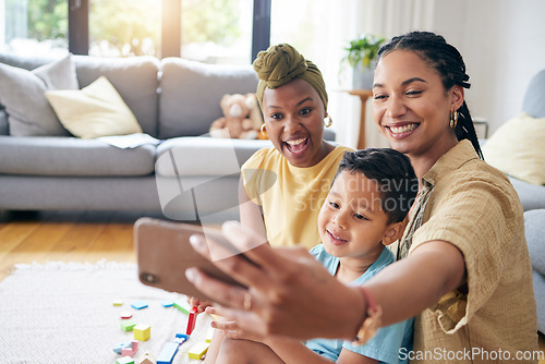 Image of Lesbian, women and son in family selfie, smile or care with toys, post or web blog on floor in home living room. Mother, male kid and happy for love, bonding or memory for social network app in house