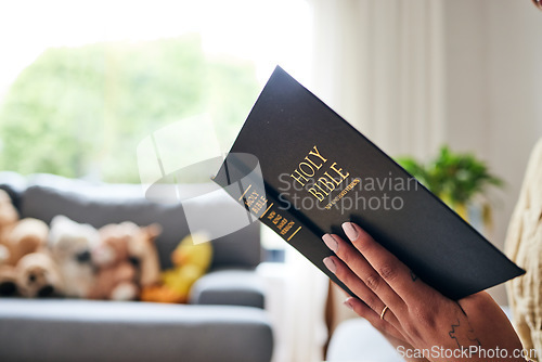 Image of Closeup, bible and hands in home for faith, studying religion or mindfulness with holy spiritual scripture. Christian literature, reading and ethics for knowledge, language or woman with Jesus Christ