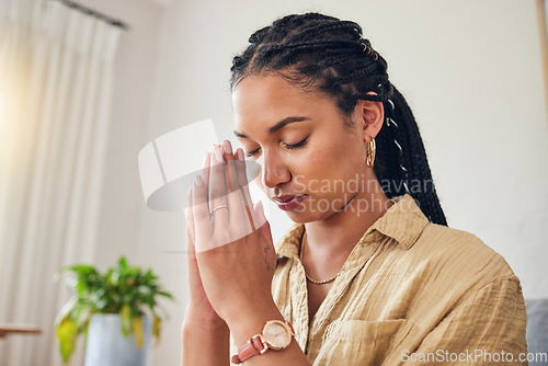 Image of Hands, worship and woman praying in her living room for hope, help or holy forgiveness in her home. God, pray and Christian female in prayer for blessing, grace and gratitude to Jesus Christ in house