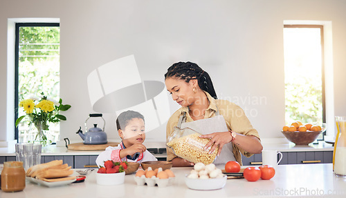 Image of Breakfast, family and a mother and child cooking, baking or helping with food in the kitchen. House, eating and a boy kid and a young mom teaching during lunch or for dinner together while hungry