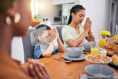 Image of Praying, breakfast and morning with family at table for food, worship or religion. Prayer, gratitude and grace with parents and child in dining room at home for Christian, spiritual or faith together