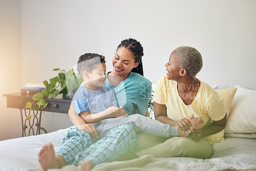 Image of Gay family, morning and playing on bed in home bedroom for bonding, quality time and love. Adoption, lesbian or LGBTQ women or interracial parents and a happy kid to wake up with fun, care and laugh