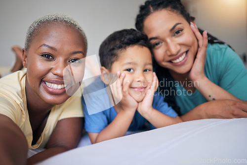 Image of Selfie, gay family and happy on a bed in home bedroom for security, quality time and love. Adoption, lesbian or LGBTQ women or interracial parents and happy kid together for social media memory