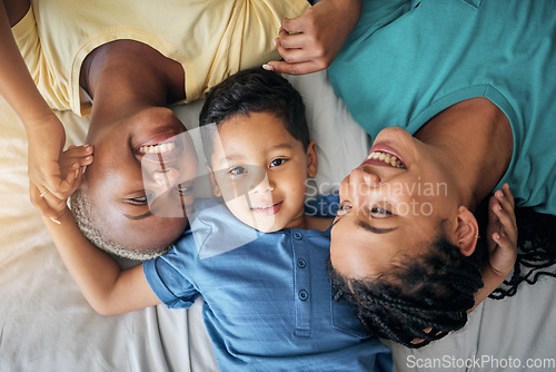 Image of LGBT family, child and happy portrait on bed in home bedroom for security, quality time and love. Adoption, lesbian or gay women or parents with a foster kid for care or relax in morning from above