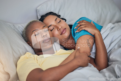Image of LGBT, bed and relax women sleeping for home wellness, rest and tired together for stress relief, fatigue or calm. Nap, cuddle and young gay people, bisexual partner or lesbian couple dream in bedroom