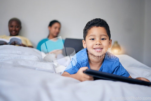Image of Kid, tablet and smile portrait in bed at family home in the morning with parents feeling relax in living room. Bedroom, education app and house with a young child online with mother and kids website