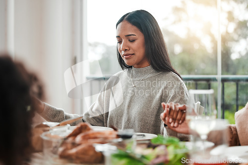 Image of Woman, praying and holding hands at family dinner at thanksgiving celebration at home. Food, female person and eyes closed at a table with religion, lunch and social gathering on holiday in house