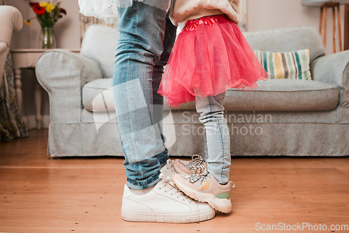 Image of Dance, feet and home with father and daughter in living room for ballet, princess and love. Music, care and learning with closeup of man and child in family house for helping, youth and energy