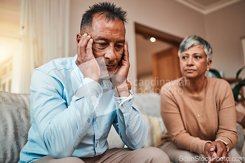 Image of Conflict, senior couple and fight on couch, divorce and depression with a breakup, cheating and stress. Sad, elderly woman and old man with mental health, home and separation with crisis and angry