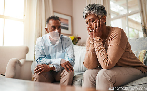 Image of Fight, senior couple and divorce on sofa, stress and conflict with a breakup, depression and home. Angry, old woman or elderly man with mental health, cheating or sad with separation, fail or mistake