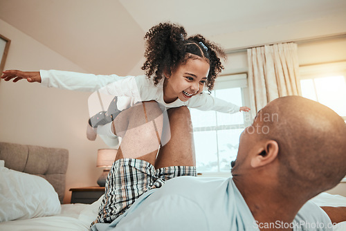 Image of Dad, child and playing airplane on bed flying for fun, quality time or bonding together in home, bedroom or girl in the air. Happy, father and daughter balance on knees with arms raised and freedom