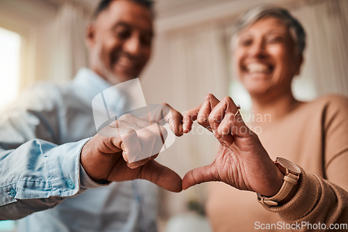 Image of Heart hands, home and senior couple with a sign, care and happiness with kindness, marriage and health. Commitment, old man or elderly woman with symbol for love, support and like with emoji or smile