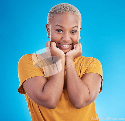 Image of Portrait, smile and fashion with a black woman on a blue background in studio for trendy clothes style. Happy, beautiful and confidence with a young female person posing in a relaxed clothing outfit