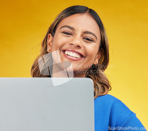 Image of Smile, laptop and portrait of woman on yellow background, networking and online influencer with internet connection. Computer, studio and face of happy content creator with social media, email or web