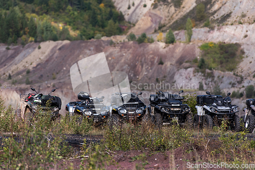 Image of Various ATV quad motors in the forest area ready for adventurous driving