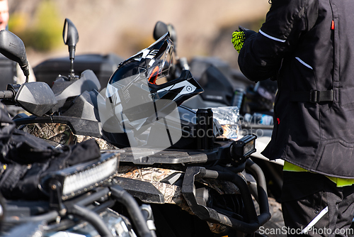 Image of A man is preparing for an adventurous ride on a quad bike