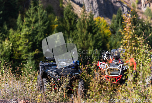 Image of Various ATV quad motors in the forest area ready for adventurous driving