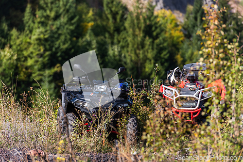 Image of Various ATV quad motors in the forest area ready for adventurous driving