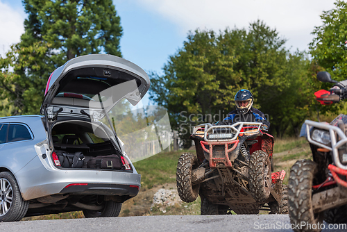 Image of Adventurous driving of ATV motorbikes. A man drives a quad bike on dangerous roads