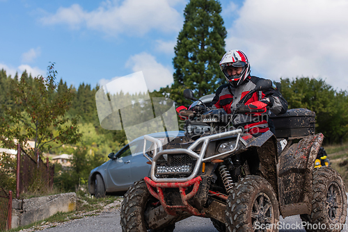 Image of Adventurous driving of ATV motorbikes. A man drives a quad bike on dangerous roads