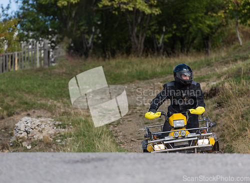 Image of Adventurous driving of ATV motorbikes. A man drives a quad bike on dangerous roads