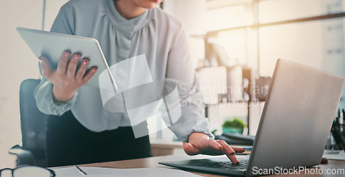 Image of Tablet, laptop and business woman hands at web analyst company with typing. Technology, female person and online professional working in a office with computer and digital data research for project