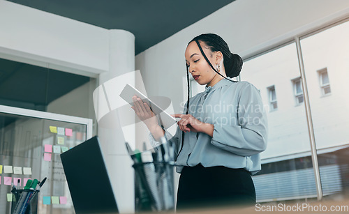 Image of Tablet, planning and business woman at web analyst company with typing. Technology, female person and online professional working in a office with computer and digital data research for project